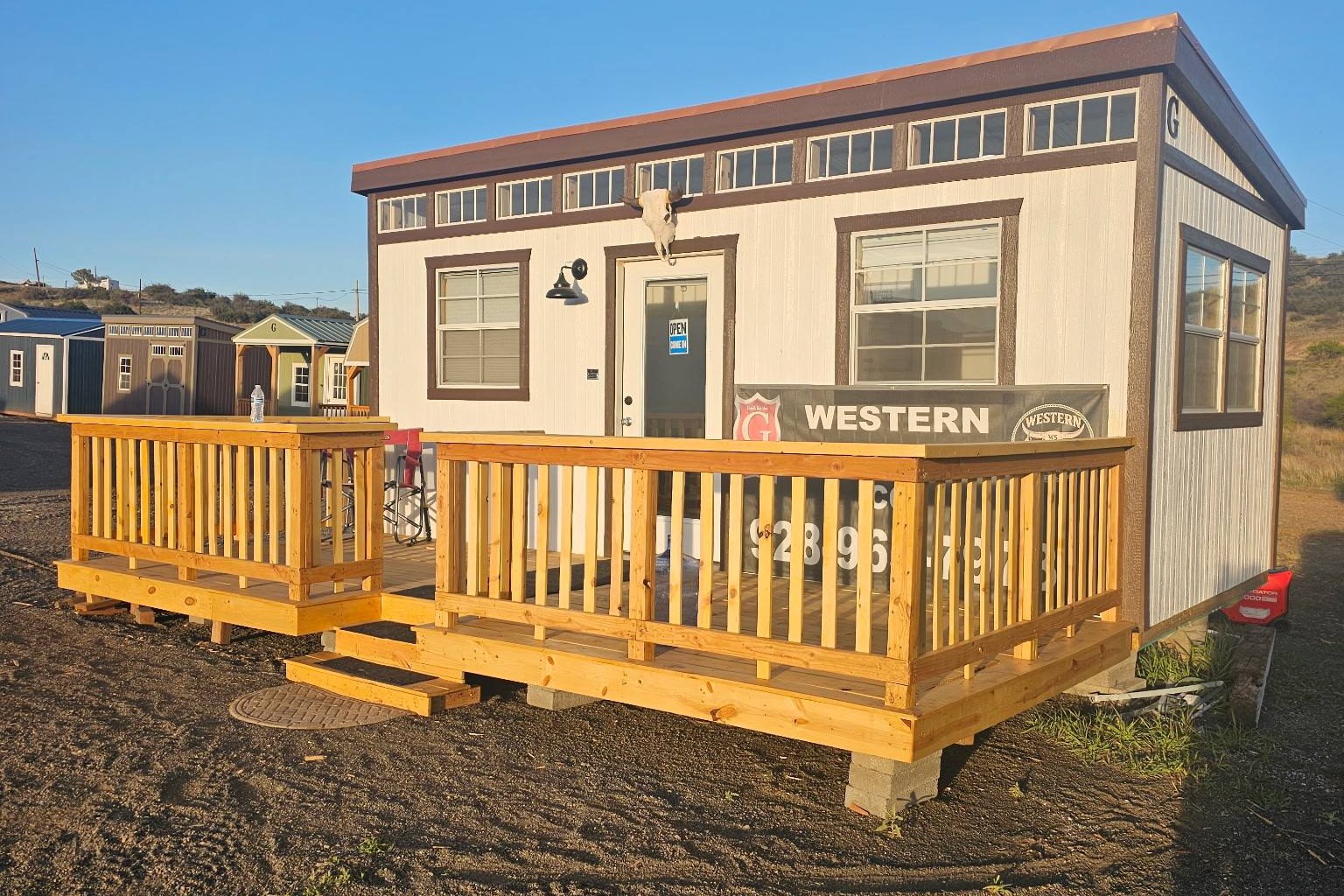 Western Structures Co. sales office and shed display lot on Highway 69 in Dewey, Arizona, with Graceland buildings lined up under a clear Arizona sky